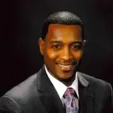 Headshot of Gerald Coleman, the director of custodial services, wearing a nice suit with a dark grey background