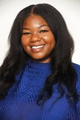 A woman on a white background wearing a blue shirt 