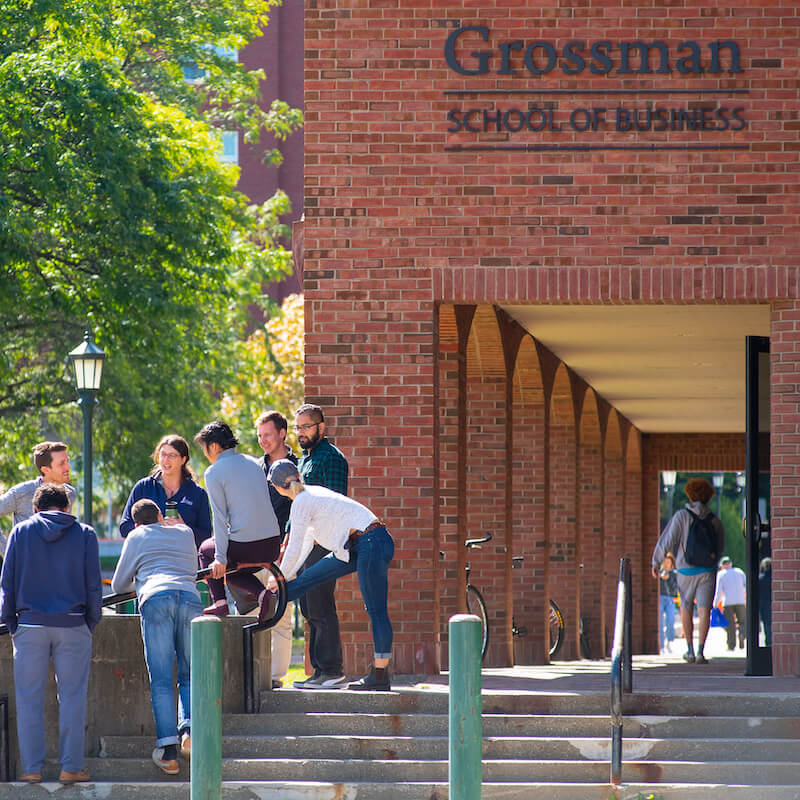 Students socializing outside of the business college.