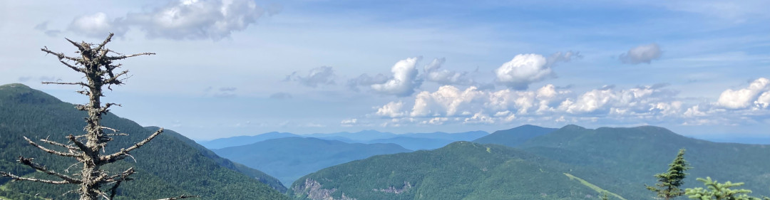 banner image of blue sky above the top of Mount Mansfield