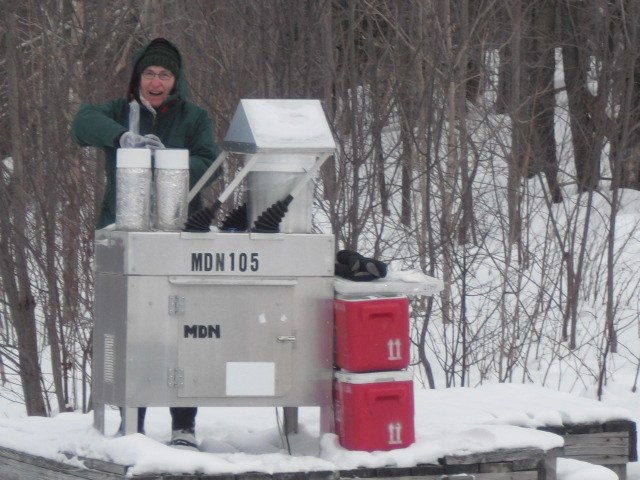 Long time site operator Mim Pendleton collecting a mercury sample at the Aerochemetrics collector. 