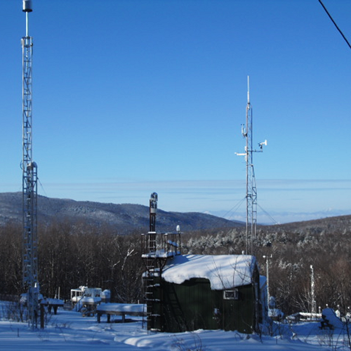 picture of monitoring equipment outside under snow under a blue sky