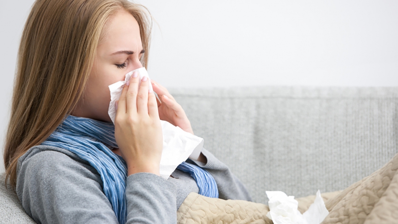 Woman sneezing