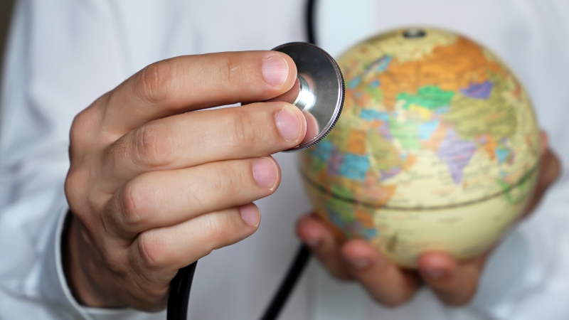 Doctor with stethoscope and globe in his hand