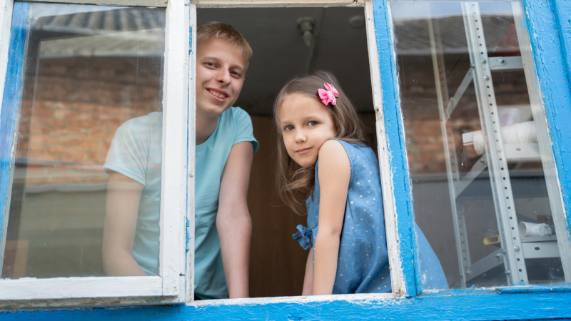 Children looking out window public health