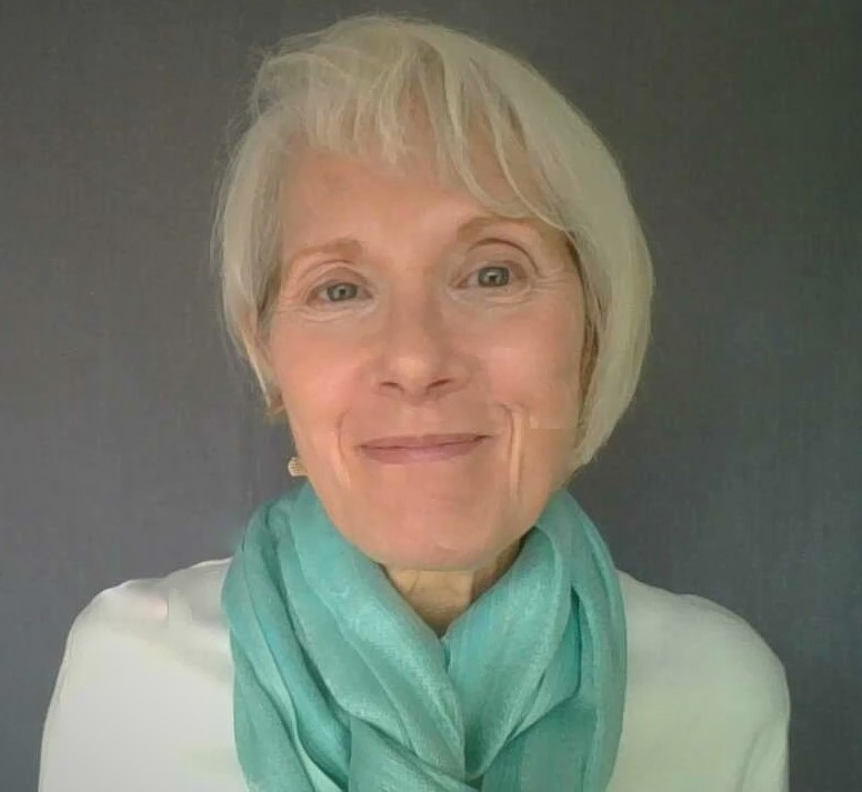 Headshot of Deb Pullin wearing a green scarf