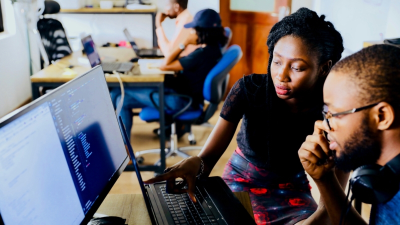 classmates looking at computer