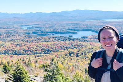 Carolyn Koestner on a hike with river valley in background