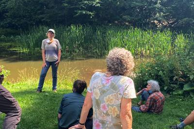 Group of people at a Green Infrastructure training near a wooded pond