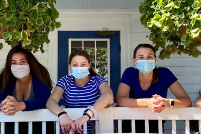 Wait staff on porch wearing face masks