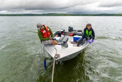Kate Warner collecting water samples off a boat in Missisquoi Bay