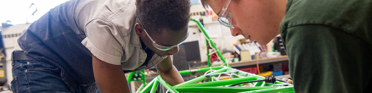 Two students working on the AERO car