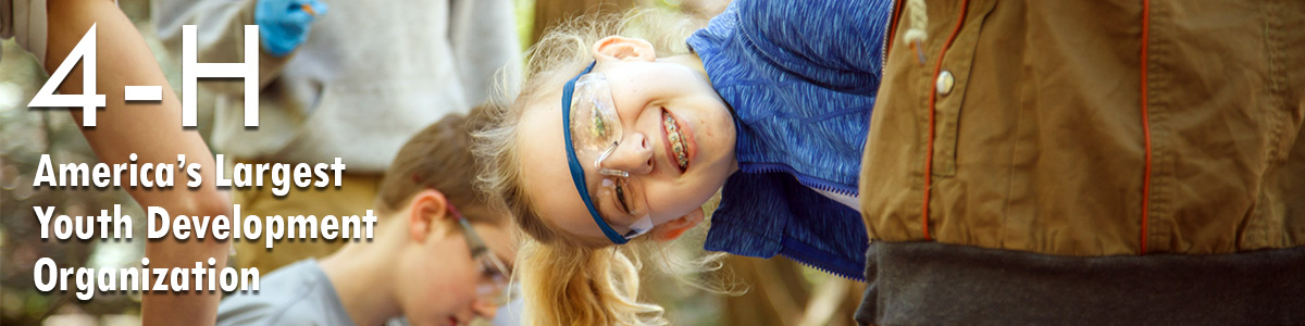 Girl with lab goggles smiling at the camera