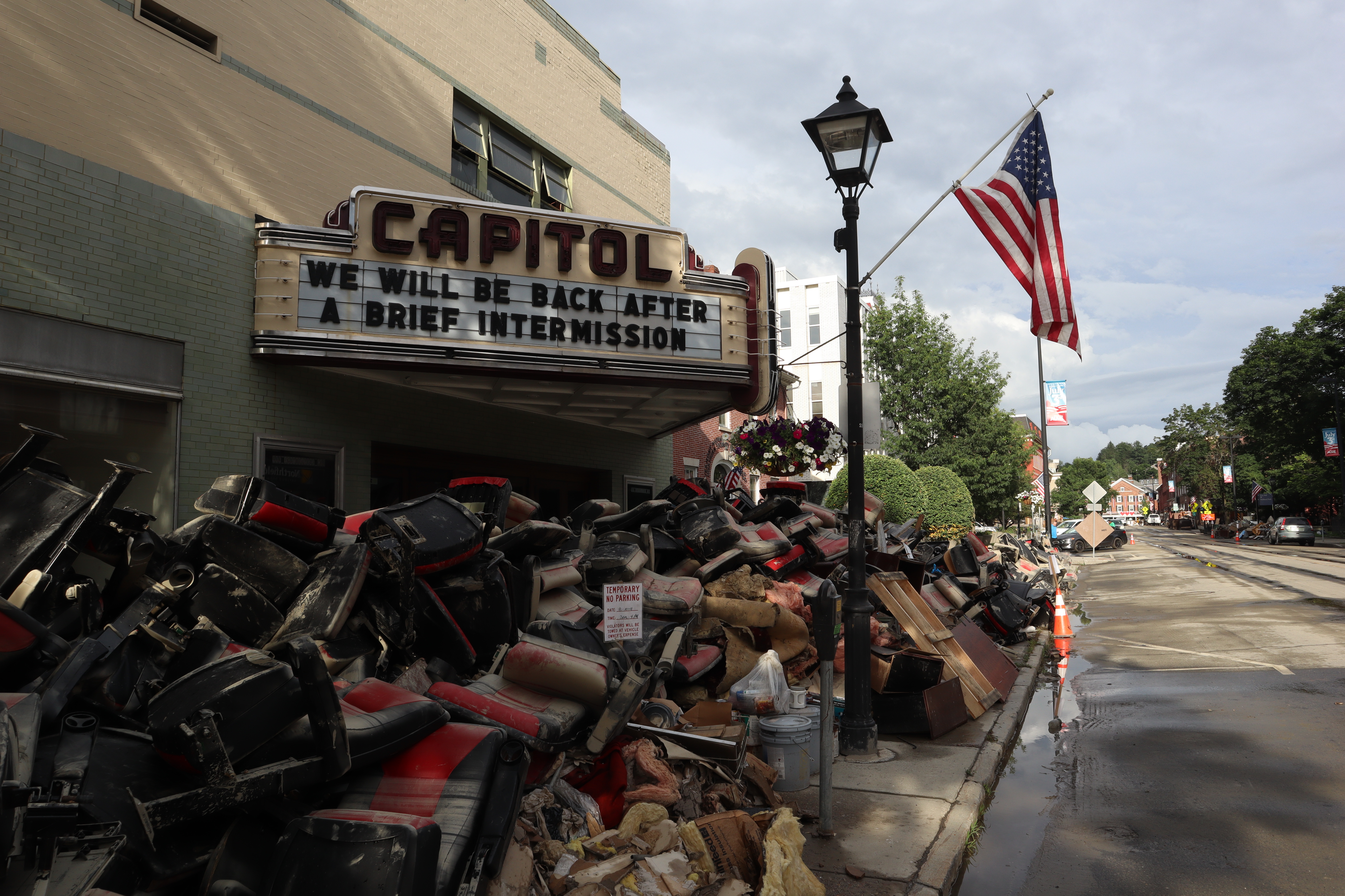 Movie theater with flood debris covering sidewalk in front