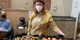 rally cat student tabling in the Davis Center with free sweet potatoes and onions