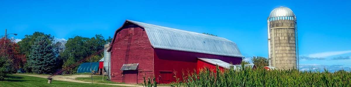 Image of an old red barn and silo