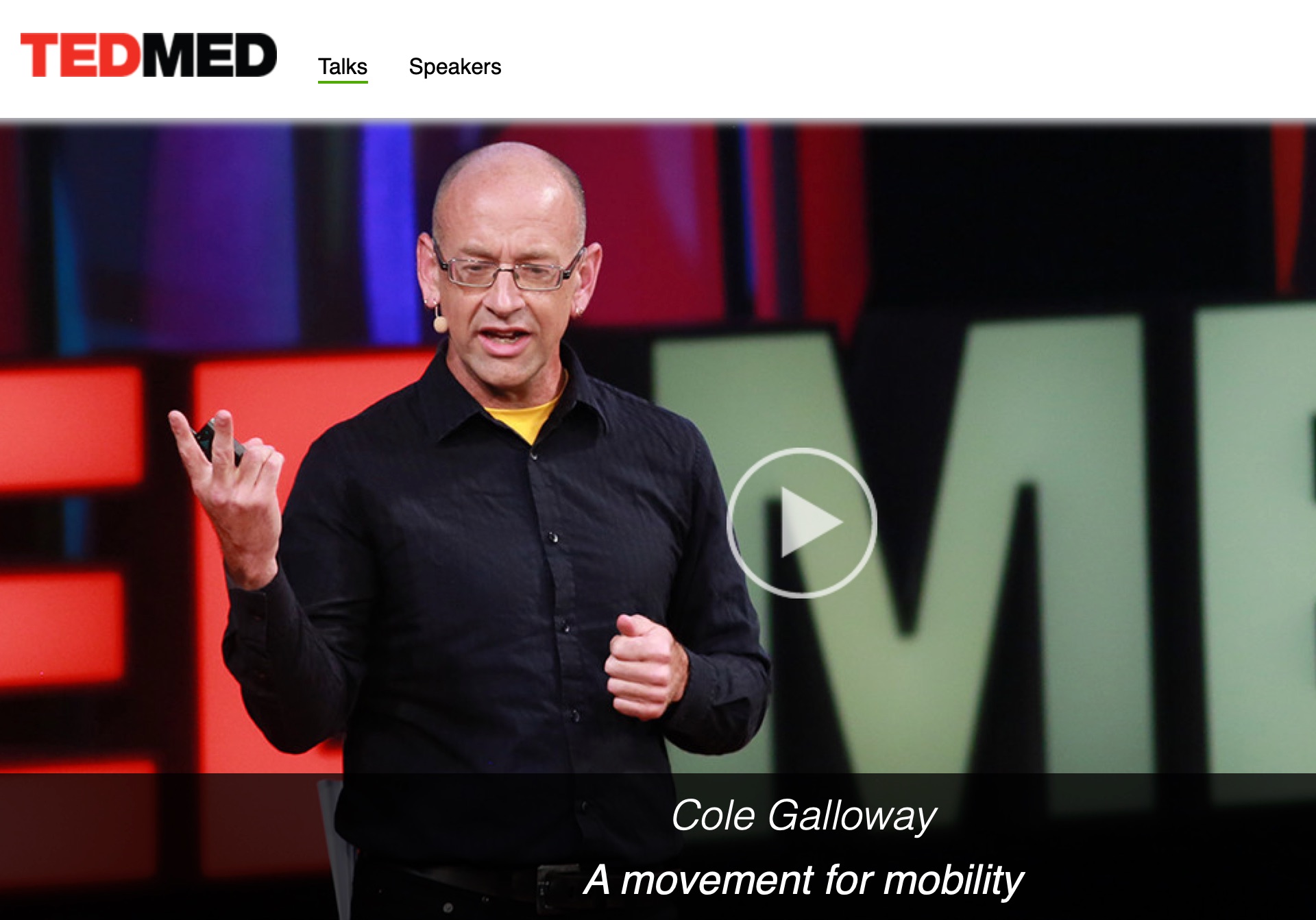Thumbnail of a TedMed talk showing a teak-skinned bald man in his late forties paused on-stage mid-talk.