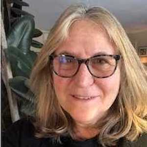 Sherry Schoenberg: a white woman in her late fifties with straight blonde hair falling to her shoulders, and dark glasses.