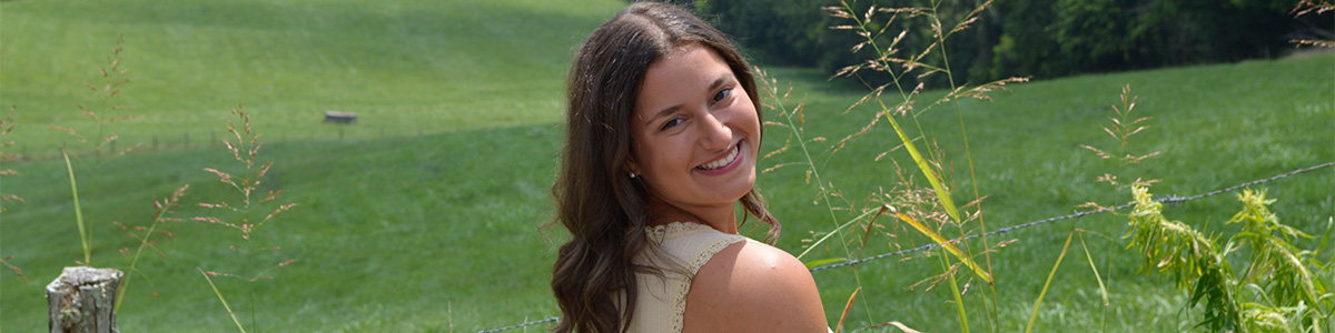 Over the shoulder smile in a sunny, outdoor setting