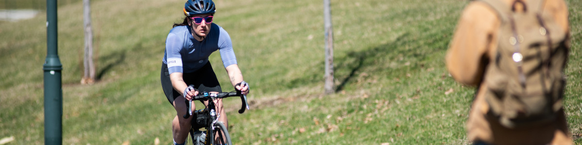 wren pyle rides her bike on UVM campus