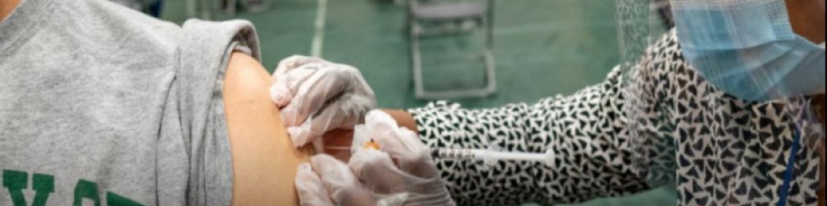 Public health volunteer administers vaccination