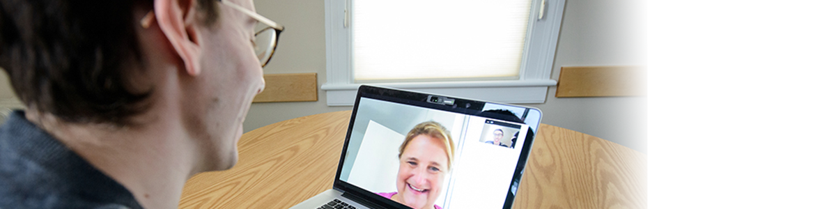 CDAE alum speaking with mentor via video chat on a laptop