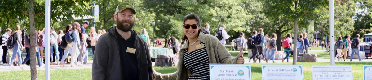 Two Staff Council Representatives give the thumbs up.