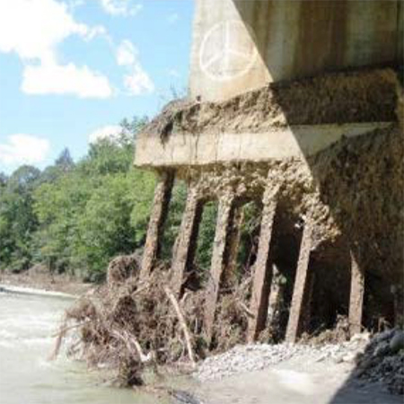 Damaged bridge with evidence of erosion and scour