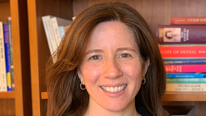 Melissa Willard Foster smiling in front of a bookcase