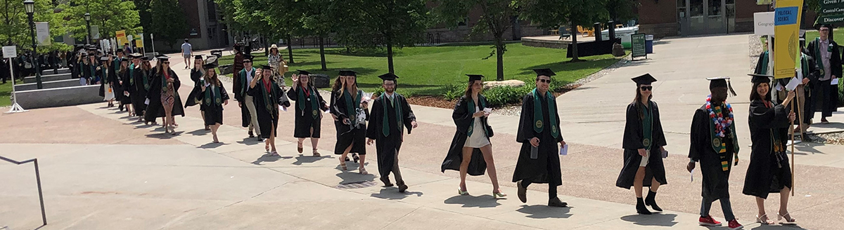 POLS grads walking in line to get their diplomas
