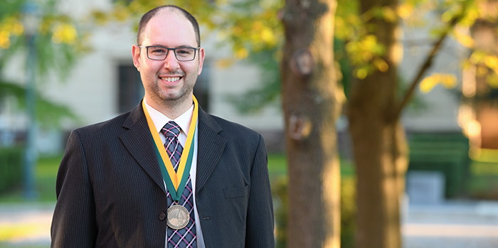 Matthew outside of Ira Allen wearing his Investiture medal