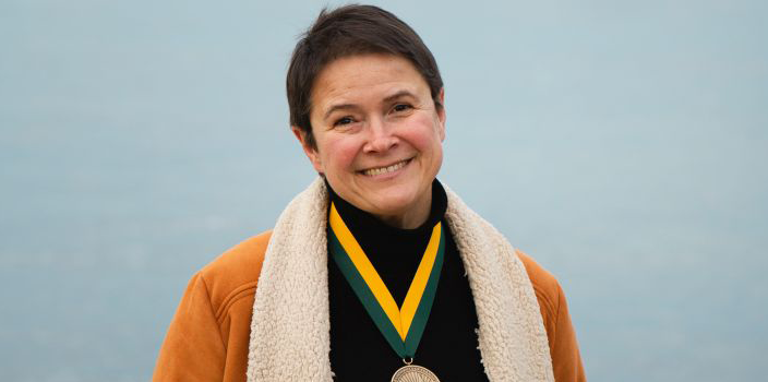 Cristina Mazzoni by lake champlain wearing a medal