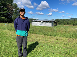 smiling student on a sunny day at the farm