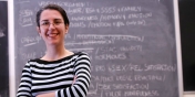 Alessandra Rellini in a classroom in front of a blackboard
