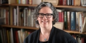 Vicki Brennan in a room with shelves lined with books floor to ceiling