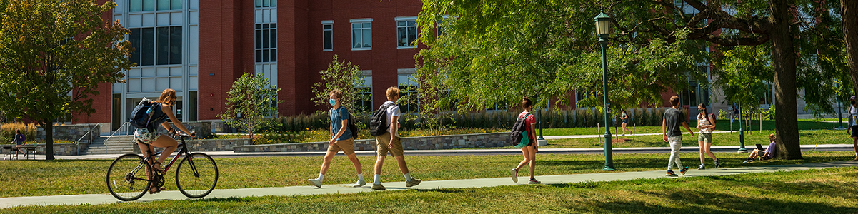 students walking across campus wearing masks
