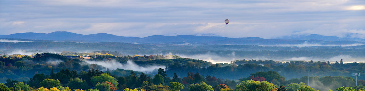 Photo of Green Mountains and floating hot air balloon