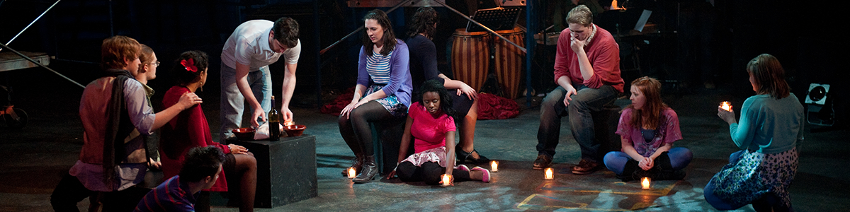 Students perform Godspell on stage.