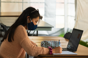 Student studying in campus tent Fall 2020