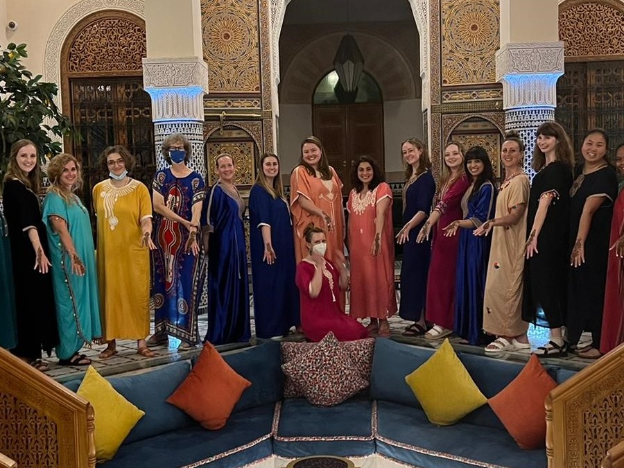 people posing for photo in front of indoor arches in Morocco