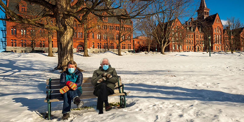 A meme depicting Jen Ellis sitting next to Senator Bernie Sanders on the UVM Green