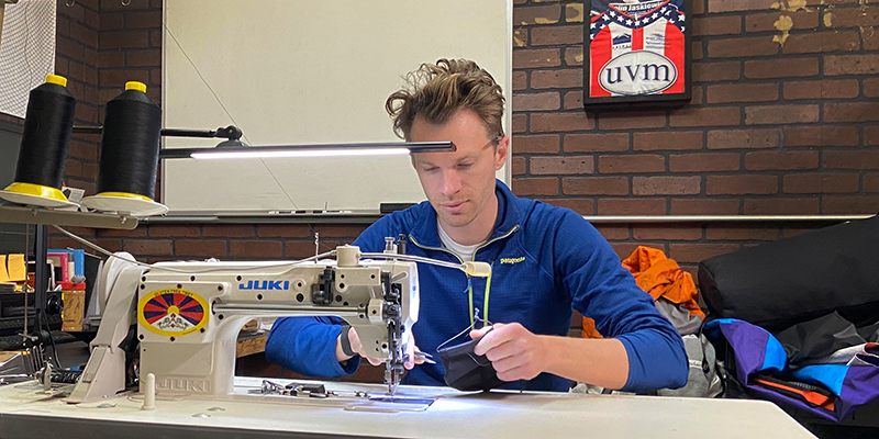 Alumnus Colin Jaskiewicz sews a prototype medical mask at Orucase headquarters in San Diego