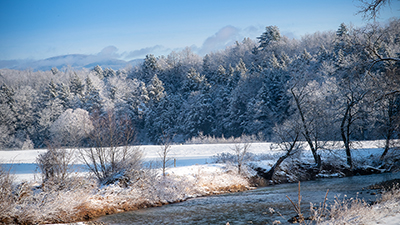 Vermont winter snowy field by a stream