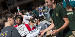 students talking at a tabling event