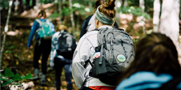 students hiking out in the woods