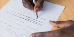 hands signing documents