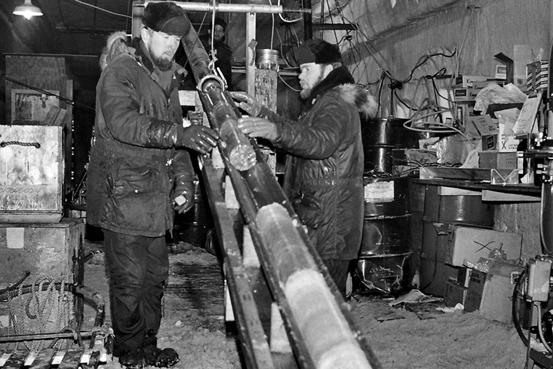 1960s era photo of two scientists working over ice core in underground lab