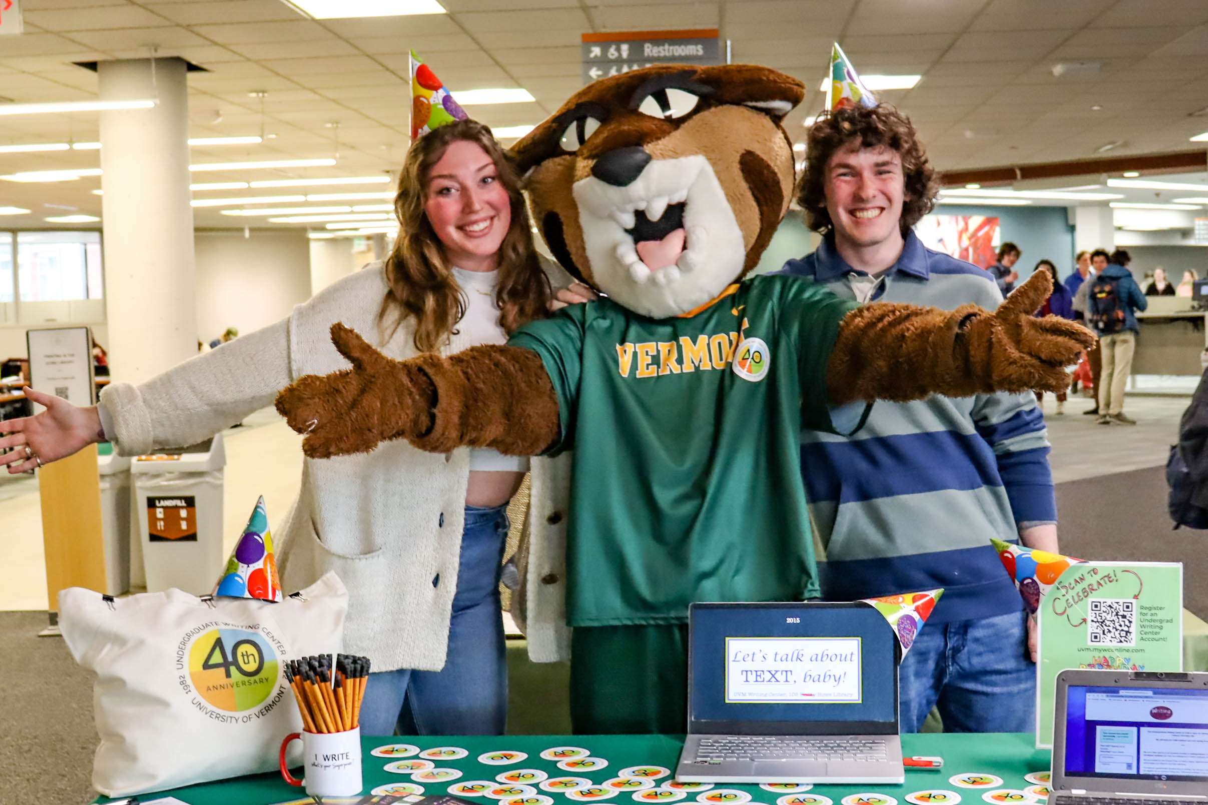 Tutor Adeline F., Rally Cat, and Tutor Ethan B. posed for a photo at the registration table.