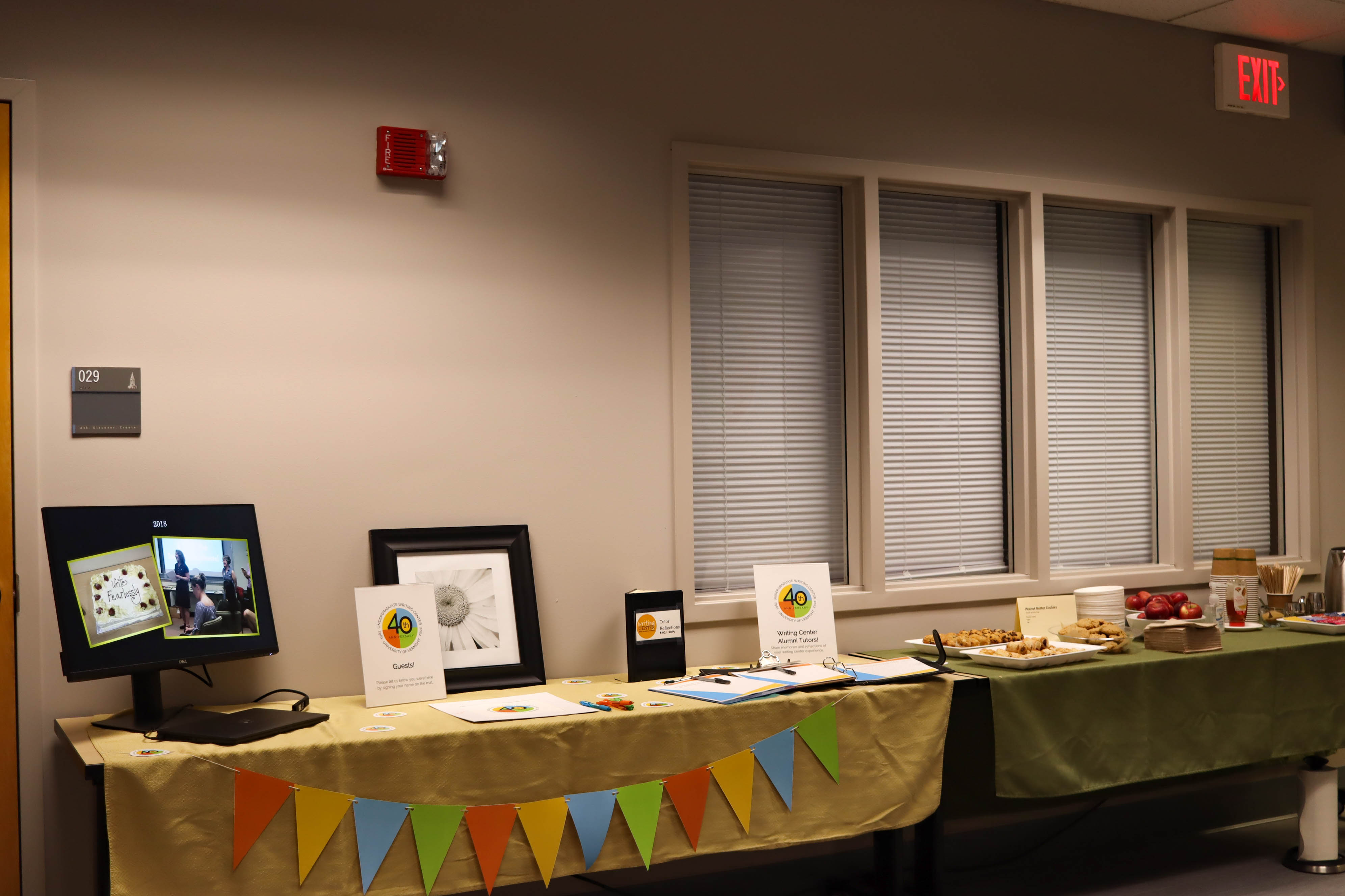 An Undergraduate Writing Center history slideshow, guest book, and snacks were out for our visitors.