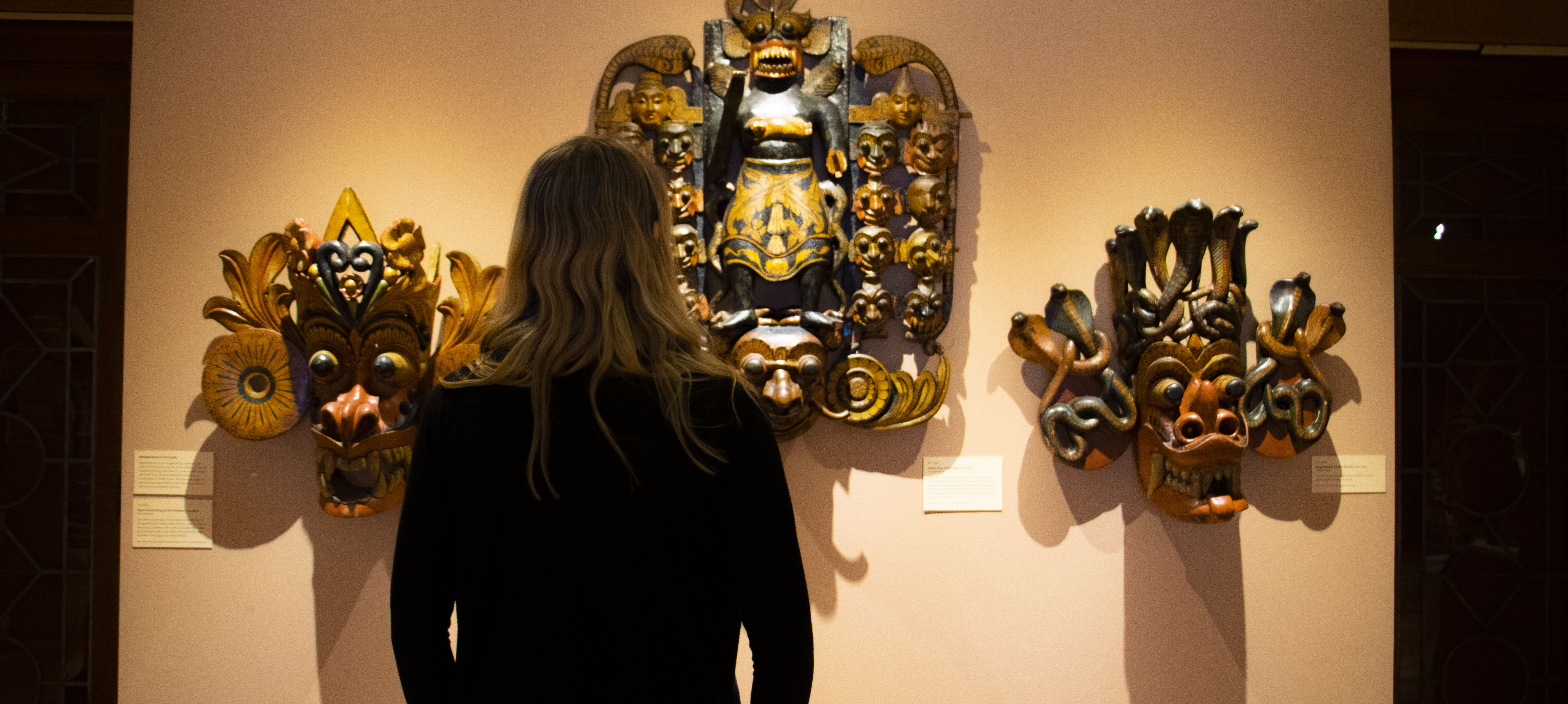 Senior Halley Malloy observes the South Asia exhibit at the Fleming Museum